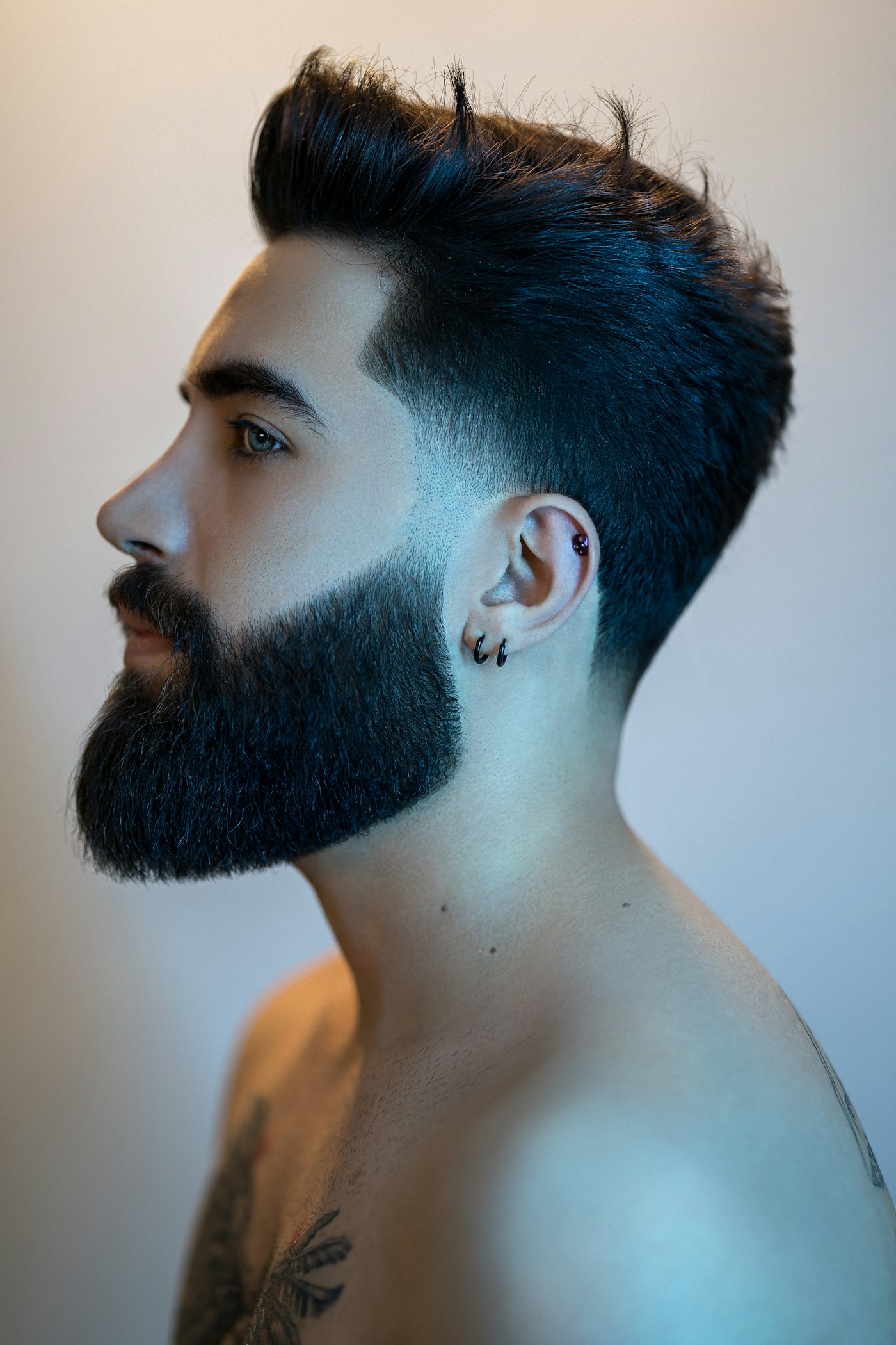 A full beard shaped and lined up, with a fade above the ear