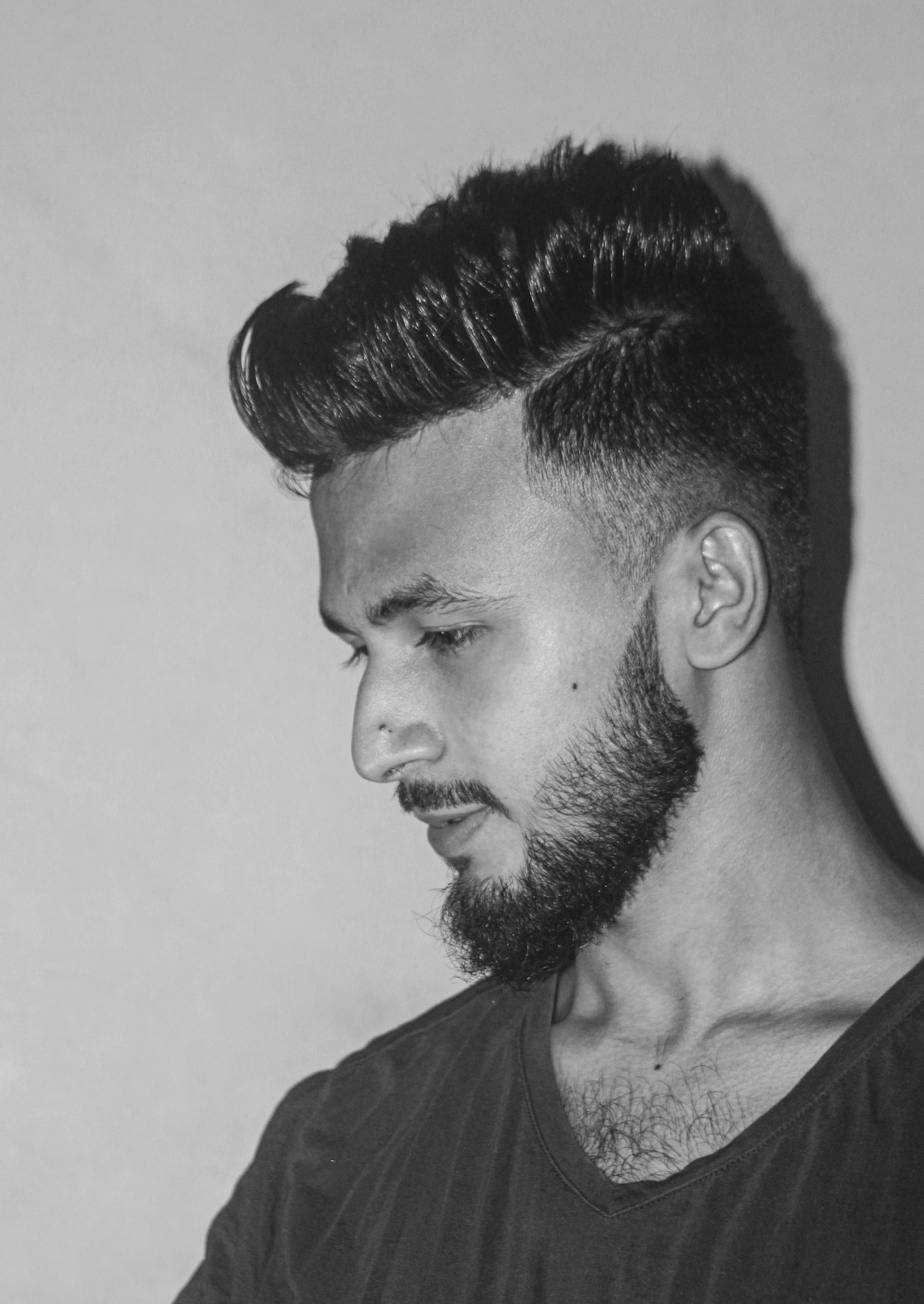 A textured quiff and tapered beard, in black and white